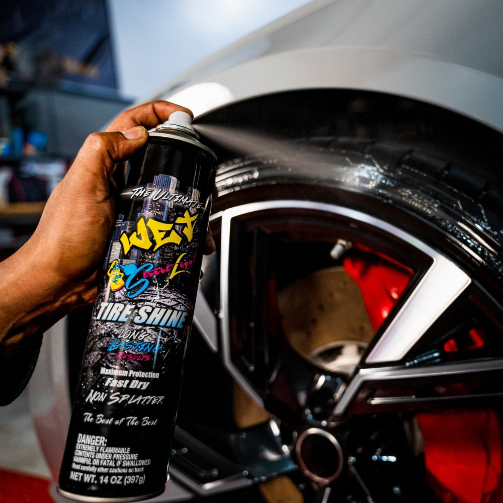 Applying Street Legal Wet Tire Shine aerosol to car tire for enhanced shine and protection