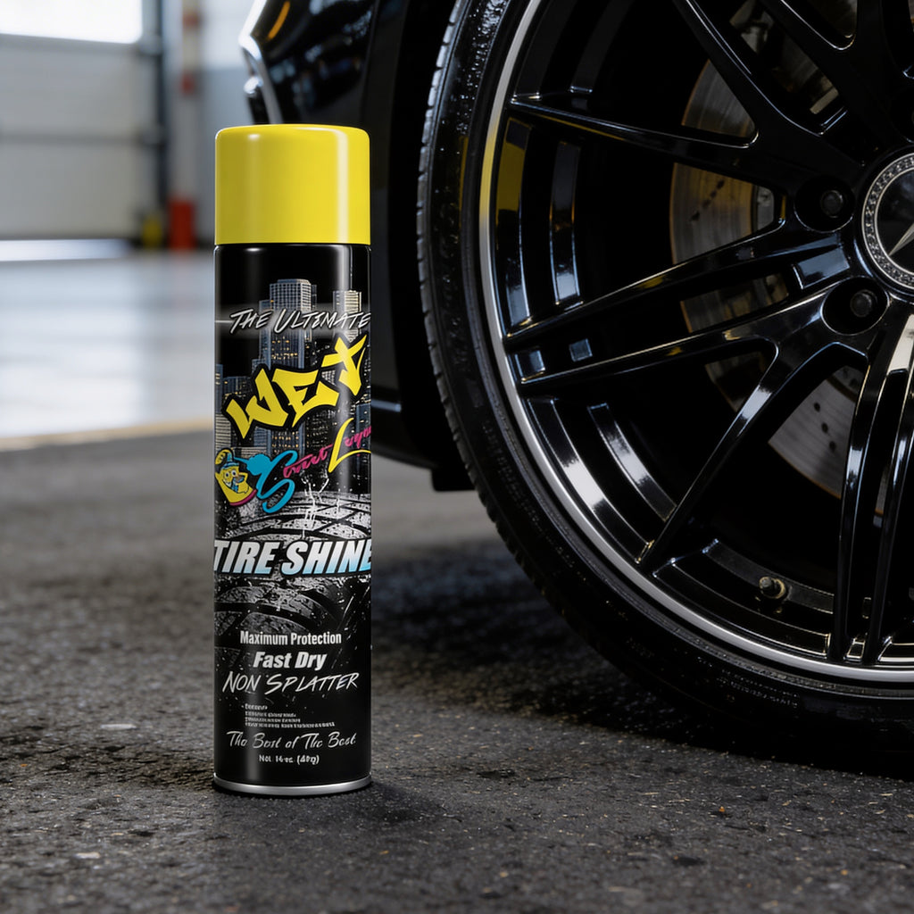 Can of tire shine next to a black car tire in a garage setting
